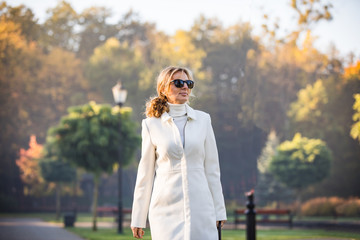 Wall Mural - middle-aged woman walking in city park