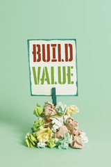 Poster - Word writing text Build Value. Business photo showcasing efficient enough way that it will generate profit after cost Reminder pile colored crumpled paper clothespin reminder blue background