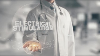 Wall Mural - Doctor holding in hand Electrical Stimulation