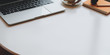 © bongkarn - Modern workplace with laptop computer and office supplies on white table