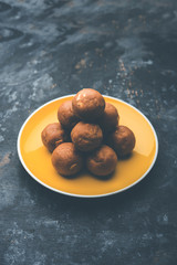 Wall Mural - Churma Ladoo / atta laddoo / wheat flour laddu made using ghee and jaggery or sugar. selective focus