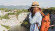 © Kenstocker - Traveler women with backpack taking photos of view and grand canyon in the nature.