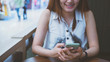 © Kenstocker - women smile and holding smartphone in the concept of happy with internet social