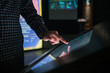 © zyabich - Man hand using interactive touchscreen display of electronic multimedia terminal at modern museum or exhibition. Evening time, low light illumination. Education, futuristic and technology concept