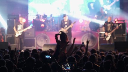 Wall Mural - Crowd of fans are cheering at open-air rock concert