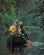 Two Girls In Canoe At The Misty River