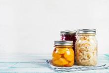 Fermented Vegetables In Jars. Sauerkraut, Pickled Beets And Pickled Squash On A Light Wooden Background. Traditional Russian Pickles. Copy Space