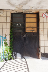 Wall Mural -  Old vintage wall with worn metal door