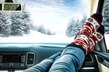 Winter Time And Car Interior With Woman Legs And Christmas Socks 