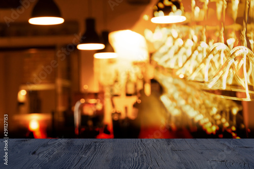 Cuadros en Lienzo top of black wood table with blur alcohol drinking glass and lamp hanging in bar