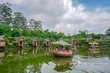 Panorama of a lake surrounded by wooden houses with boats in Bamboo Village (Dusun Bambu) at Lembang, Bandung, Indonesia.