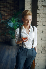 Wall Mural - Woman holding glass of whiskey, retro fashion