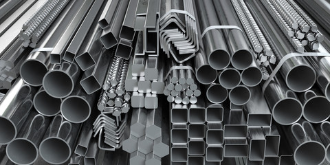 different metal rolled products. stainless steel profiles and tubes. in warehouse background.