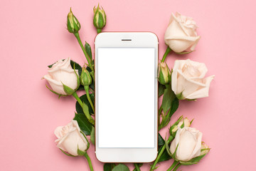 Mobile phone with roses flowers on pink pastel background, women technology concept