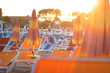 Rimini, Italy. Summer resort beach with sun chaise lounges and umbrellas on sandy beach in Rimini