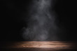 Leinwanddruck Bild - empty wooden table with smoke float up on dark background