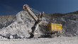Heavy excavator inside the quarry for limestone mining, panorama. Mining industry. Heavy equipment.