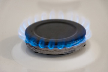 Energy efficiency concept with gas cooker – the cost of natural gas is more expensive. Close up, selective focus.