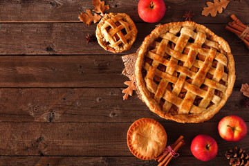 Poster - Homemade autumn apple pie corner border. Top view table scene over a rustic wood background with copy space.