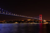 Fototapeta  - The Bosphorus Bridge or the 15 July Martyrs Bridge, view on the Asian side of night Istanbul, Turkey