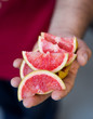 © Luis Garcia - Hand holdings wedges of red oranges
