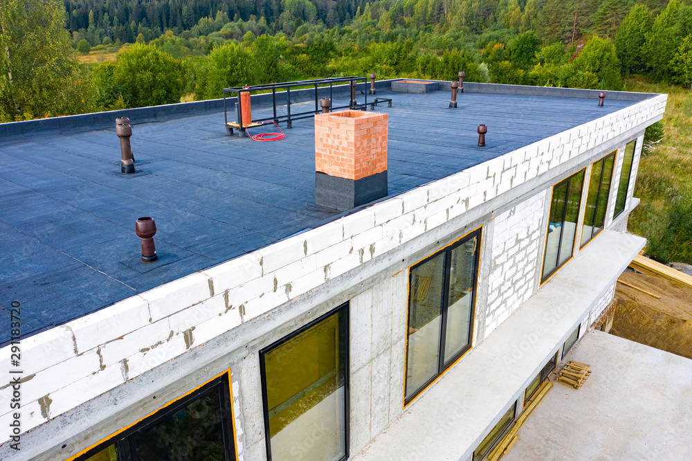 Roof waterproofing. Building construction. A protective layer was applied on the roof of the house. Installation of a waterproofing layer. Construction works. Bitumen insulating layer. - obrazy, fototapety, plakaty 
