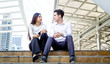 © FotoArtist - young business people sitting on step outdoor