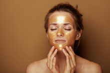 Modern Woman With Golden Mask Making Facial Self Massage