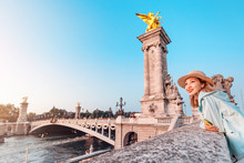 Happy Asian Woman Traveler Standing On A Alexander III Bridge In Paris. Tourism In France