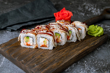 Sticker - The dragon roll with eel on the board on grey concrete table