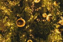 Close-up Christmas Tree With Decoration, Light And Gold Ball At Night In Christmas And New Year Holiday.