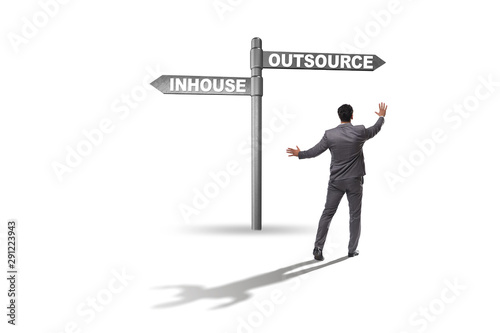 Fotografía Businessman at crossroads deciding between outsourcing and inhou