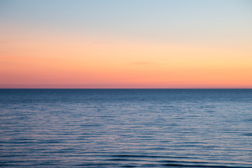 Canvas Print - Beautiful Summer landscape sunset image of colorful vibrant sky over calm long exposure sea