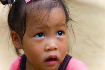 Toddler's Face looking for something and sweaty on her face .