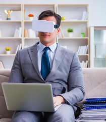 Businessman with virtual reality glasses in modern technology co