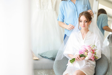 Wall Mural - Professional hairdresser working with young bride at home