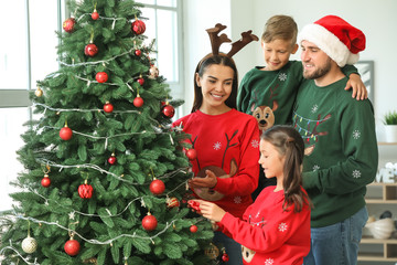 Wall Mural - Happy family decorating Christmas tree at home