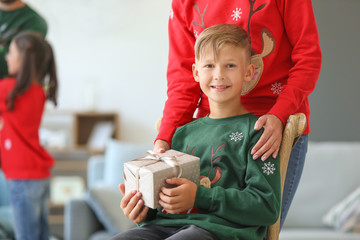 Sticker - Mother giving Christmas present to her little son at home