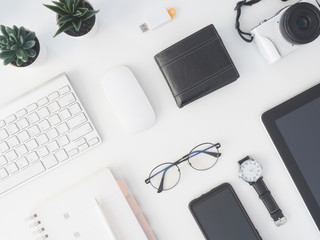 Poster - top view of office desk table with notebook, plastic plant, digital camera and keyboard on white background, graphic designer, Creative Designer concept.