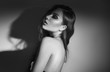 © Subbotina Anna - Sexy Young Woman black and white portrait. Seductive young woman in lingerie in darkness. Glamour lady with long hair posing in spotlight. Gorgeous seductive model girl with long hair b&w