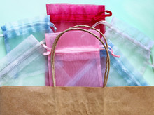 Organza Bags And Recycled Eco Bag On Blue Background. Organza Bags Can Be Used For Storage Different Things For A Long Time. Waste Zero Reuse Concept. Eco-friendly Design