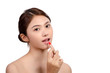 © chaiwat - Portrait of Beautiful Asian women With Applying Lip on white background