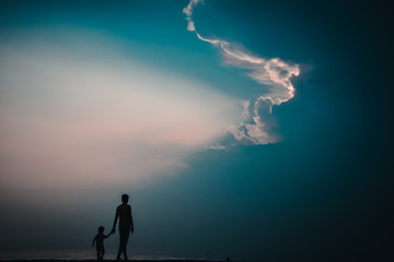 Wall Mural - silhouette of man on top of mountain