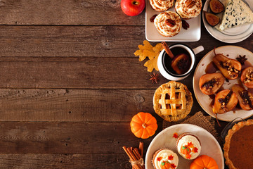 Poster - Autumn food side border. Table scene with a selection of pies, appetizers and desserts. Top view over a rustic wood background. Copy space.