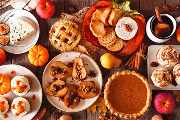 Poster - Autumn food concept. Selection of pies, appetizers and desserts. Top view table scene over a rustic wood background.