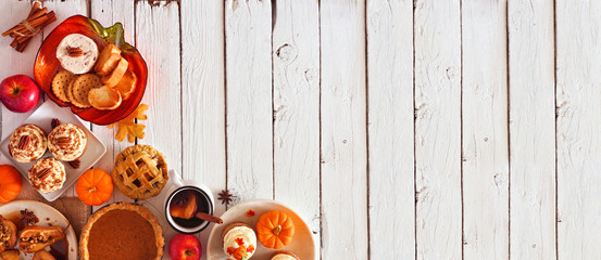 Wall Mural - Autumn food corner border banner. Table scene with a selection of pies, appetizers and desserts. Top view over a white wood background. Copy space.