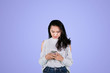 © Creativa Images - Pretty girl texting on a mobile phone in studio