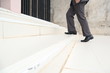 © MemoryMan - Business man step up stair.Lower part of Man in business shoes walking up stair,People lifestyle successful and competition concept