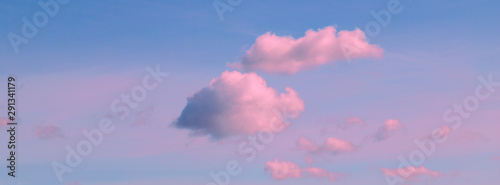 Banner blue sky background with pink clouds.