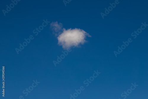 Single cumulus cloud on blue sky on a sunny day.